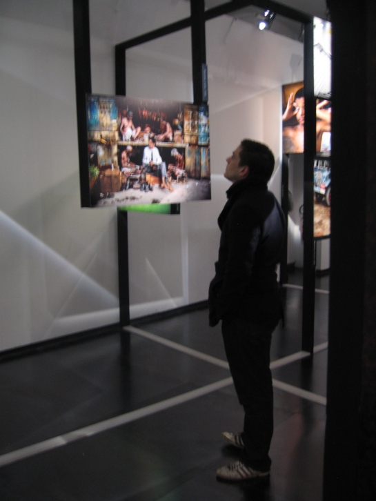 A visitor appears entranced by one of the lovely, wondrous images in the last display room.